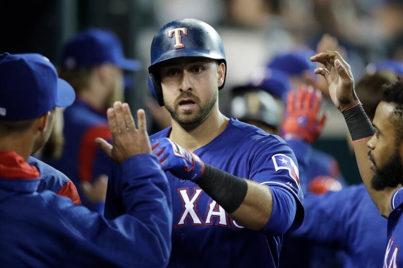 Texas Rangers' Joey Gallo is greeted by teammates after hitting a two-run home run during...