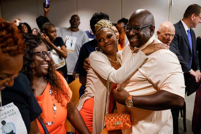 Tyrone Day (right) hugs daughter Tyronda Frost after being exonerated at the Frank Crowley...