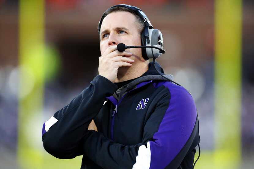 Northwestern head coach Pat Fitzgerald watches the scoreboard during the first half of a...