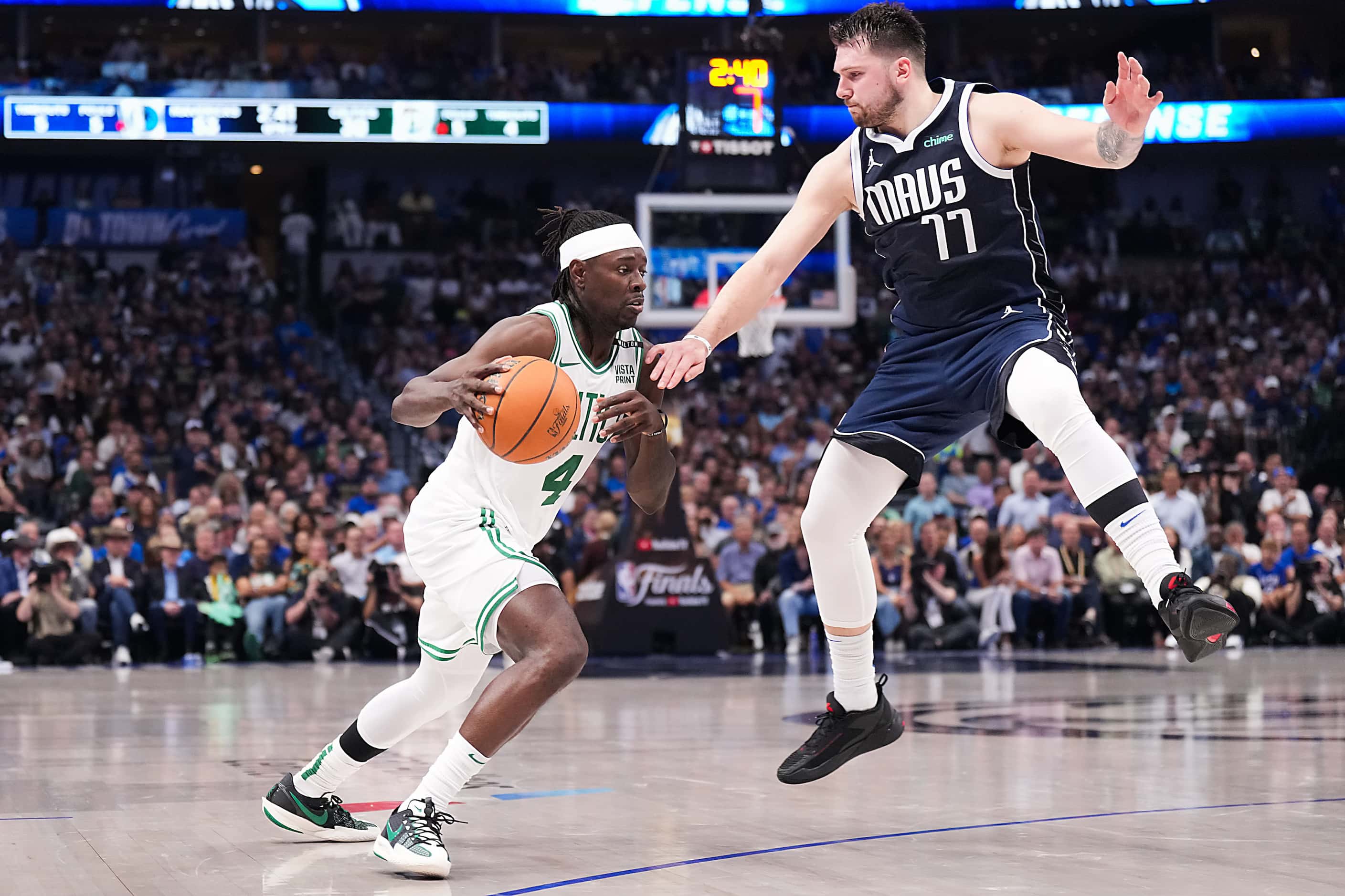 Dallas Mavericks guard Luka Doncic (77) defends against Boston Celtics guard Jrue Holiday...