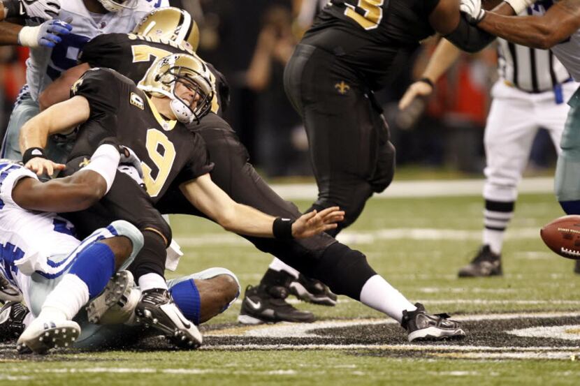 Dallas Cowboys DeMarcus Ware (94) causes New Orleans Saints Drew Brees (9) to fumble during...