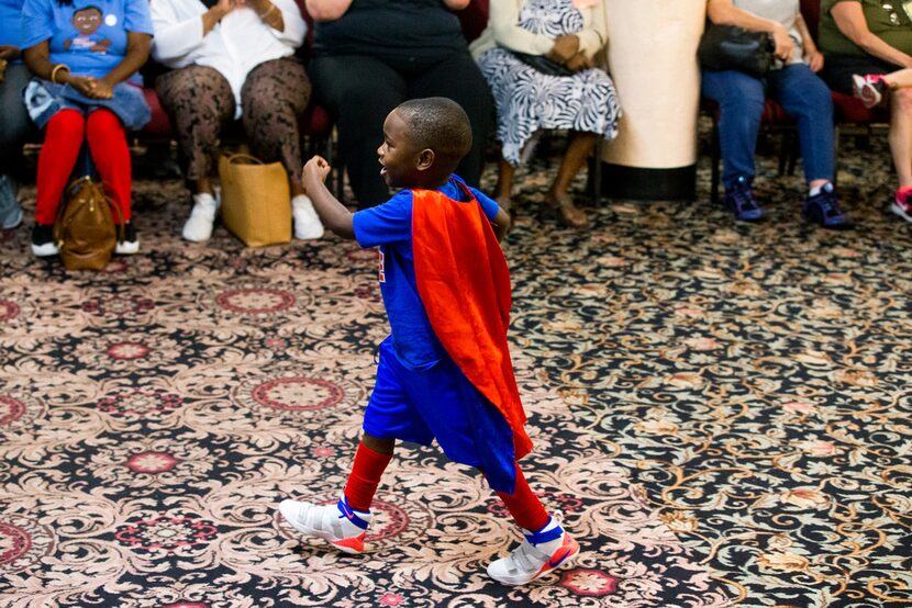 "President" Austin Perine, 4, walks to the kitchen to serve food to the homeless at Dallas...