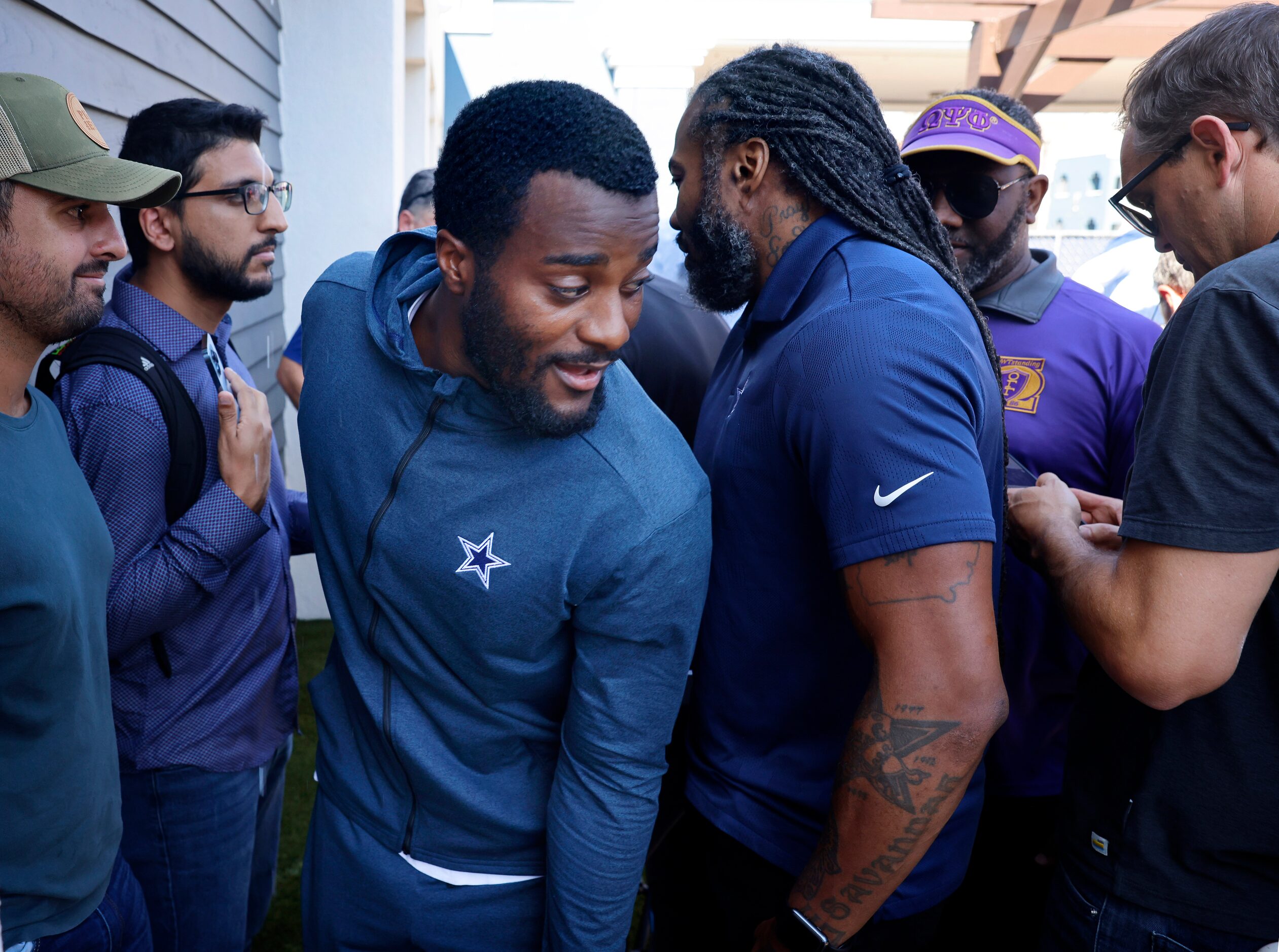 Dallas Cowboys cornerback Jourdan Lewis waves his way out of a media scrum after answering...