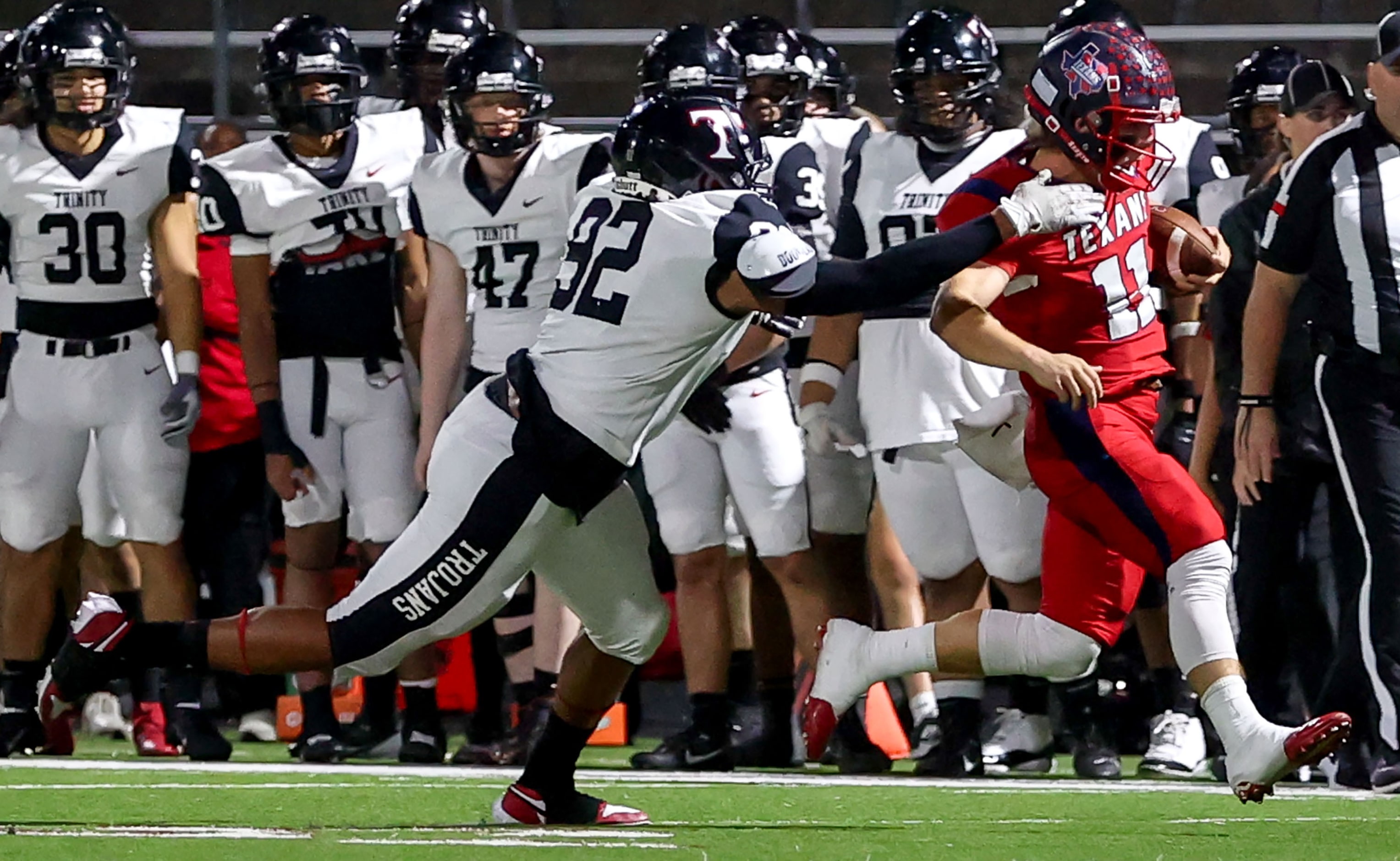 Justin Northwest quarterback Ryder Norton (11) tries to get past Trinity defensive lineman...