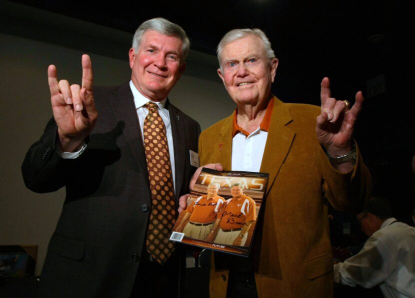 Texas football coach Mack Brown, left, with former coach Darrell Royal at a reception before...