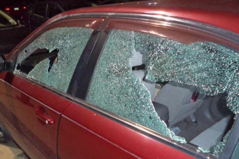 Police are investigating after windows of several vehicles, including a police squad car,...