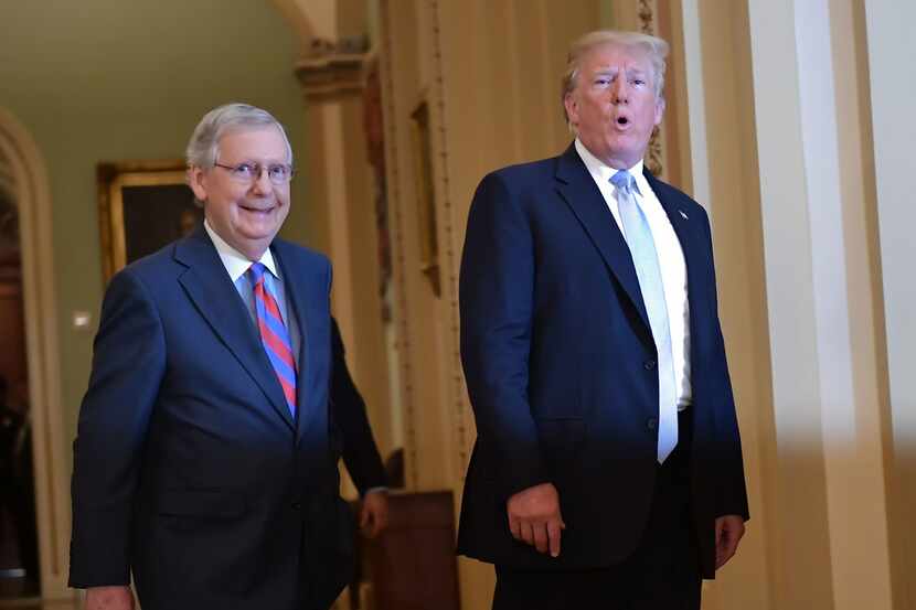 President Donald Trump and Senate Majority Leader Mitch McConnell make their way to a Senate...