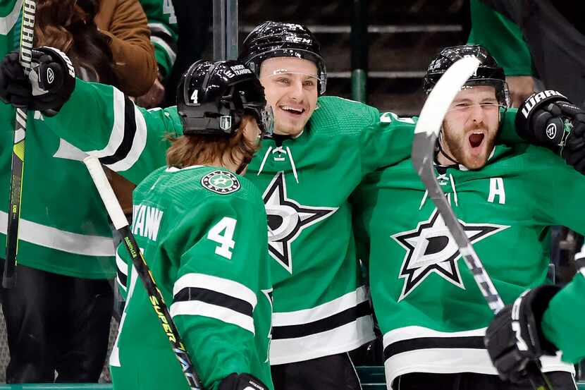 Dallas Stars center Tyler Seguin (91, second from right) is congratulated by teammates after...