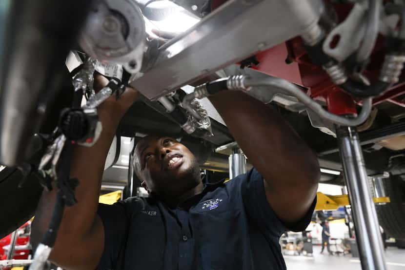 Emmanuel Walker installs a Ford F-150 transmission into a truck at Five Star Ford.
