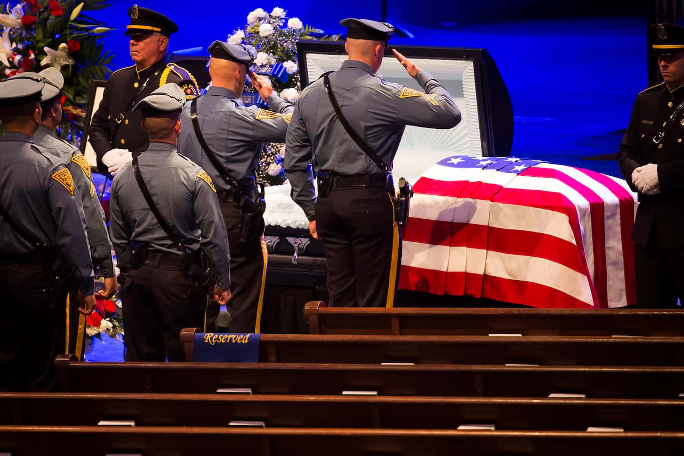 A group of Oregon State Patrol officers salutes the casket of Dallas police Sr. Cpl. Lorne...