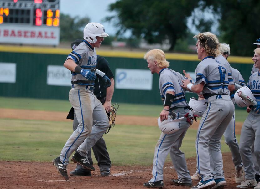 Byron Nelson's Hudson White is greeted buy teammates after his three-run home run to tie the...