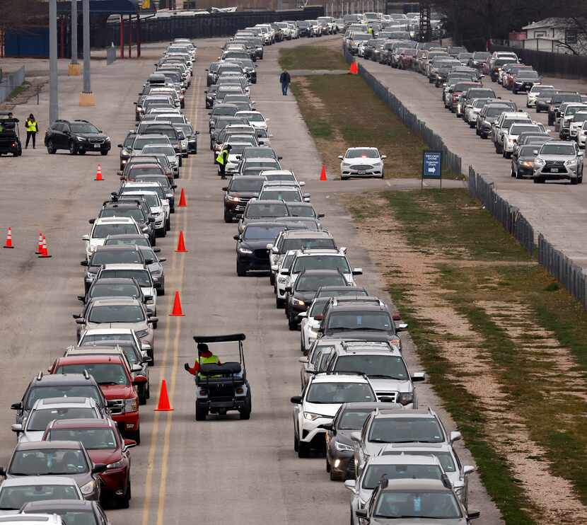 Lines of vehicles snaked around Fair Park on Feb. 10 as Dallas residents turned out to...