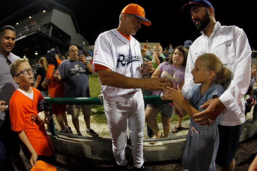 Cleburne Railroaders designated hitter Rafael Palmeiro signs autographs after the team's...