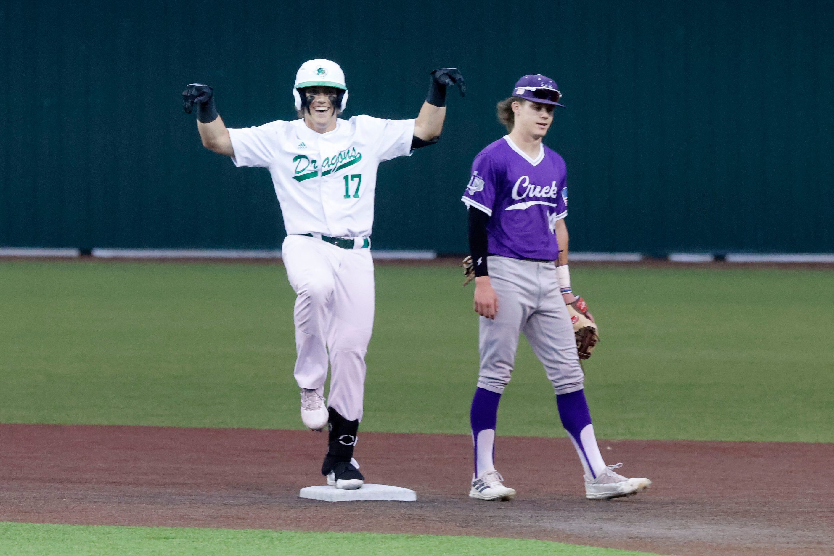 Southlake Carroll’s Cole Bedwell (17) celebrates a double in front of Keller Timber Ridge...