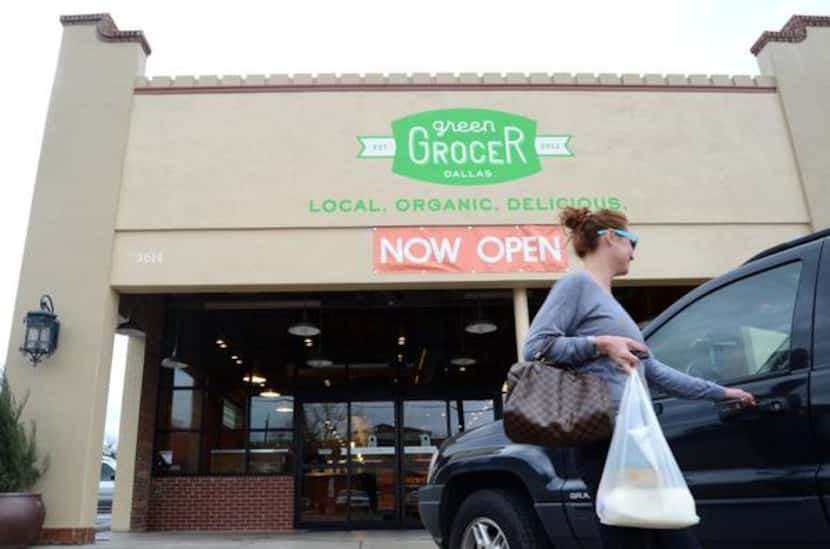 Shanna Lee of Dallas gets into her car after leaving the recently opened Green Grocer last...