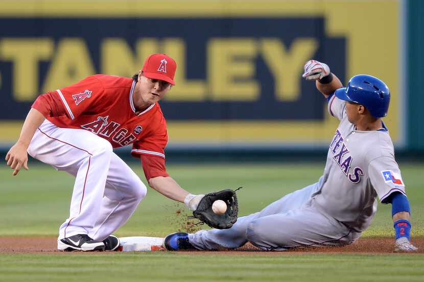 ANAHEIM, CA - AUGUST 06:  Leonys Martin #2 of the Texas Rangers steals second base behind...