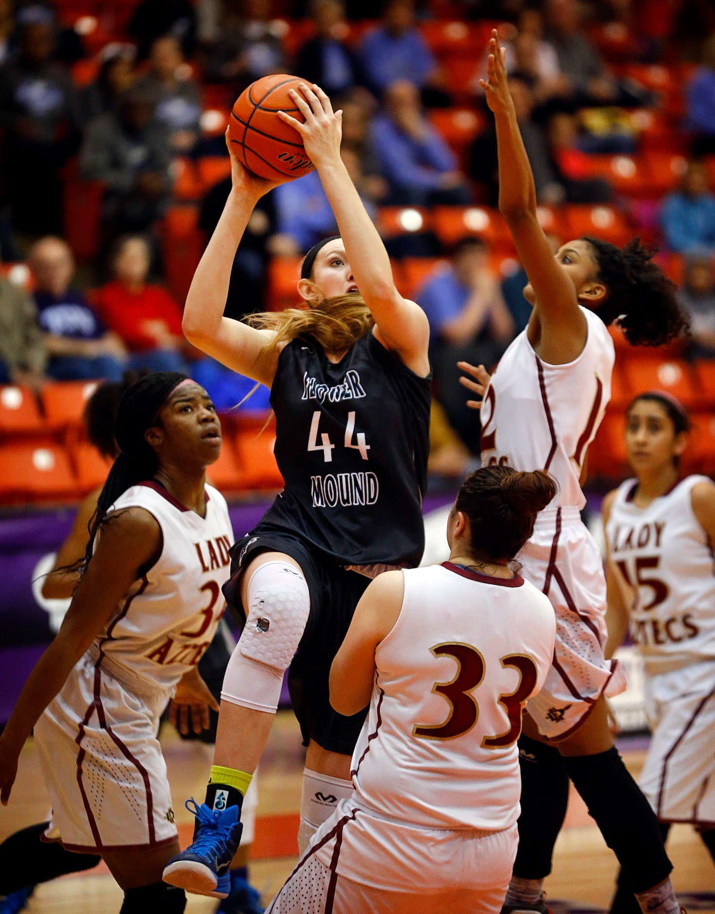 Flower Mound center Lauren Cox (44) drives through a triple team by El Paso El Dorado's...