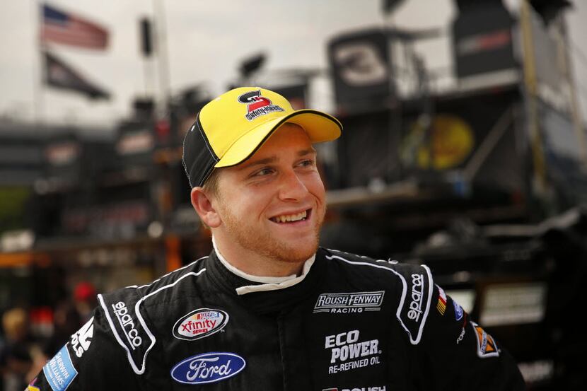 NASCAR Xfinity Series driver Chris Buescher of the No. 60 Safety-Kleen Ford flashes a smile...