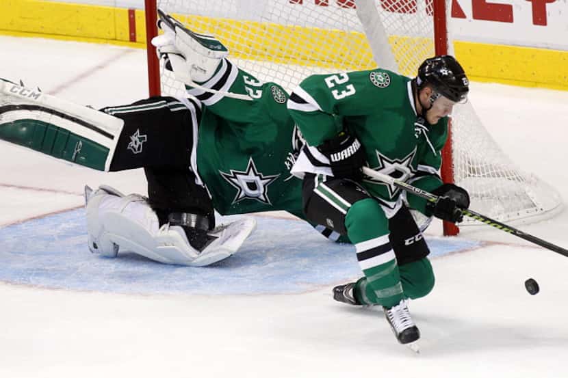 Dallas Stars defenseman Kevin Connauton (23) stops a shot on goal by the Calgary Flames in...