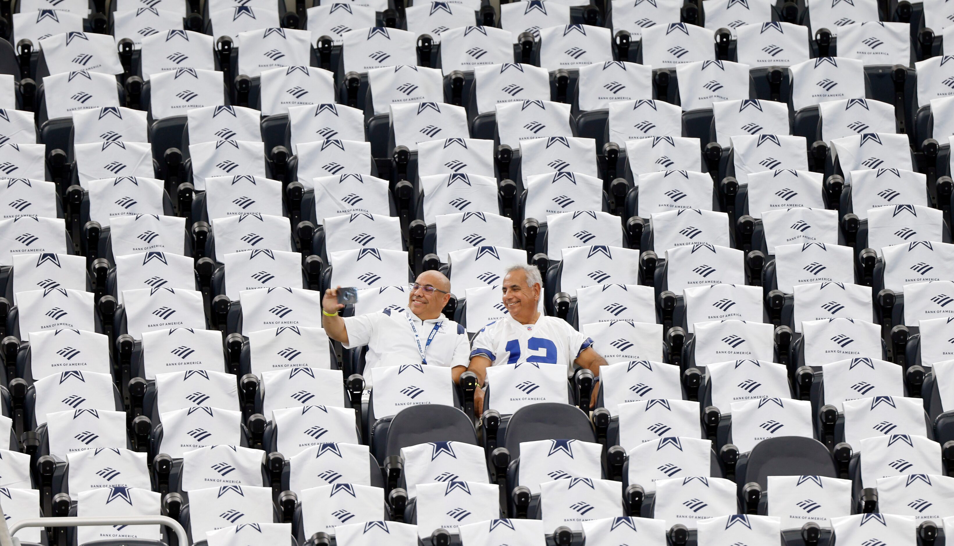 Dallas Cowboys fans take a selfie as they settle into their seats before they face the Tampa...