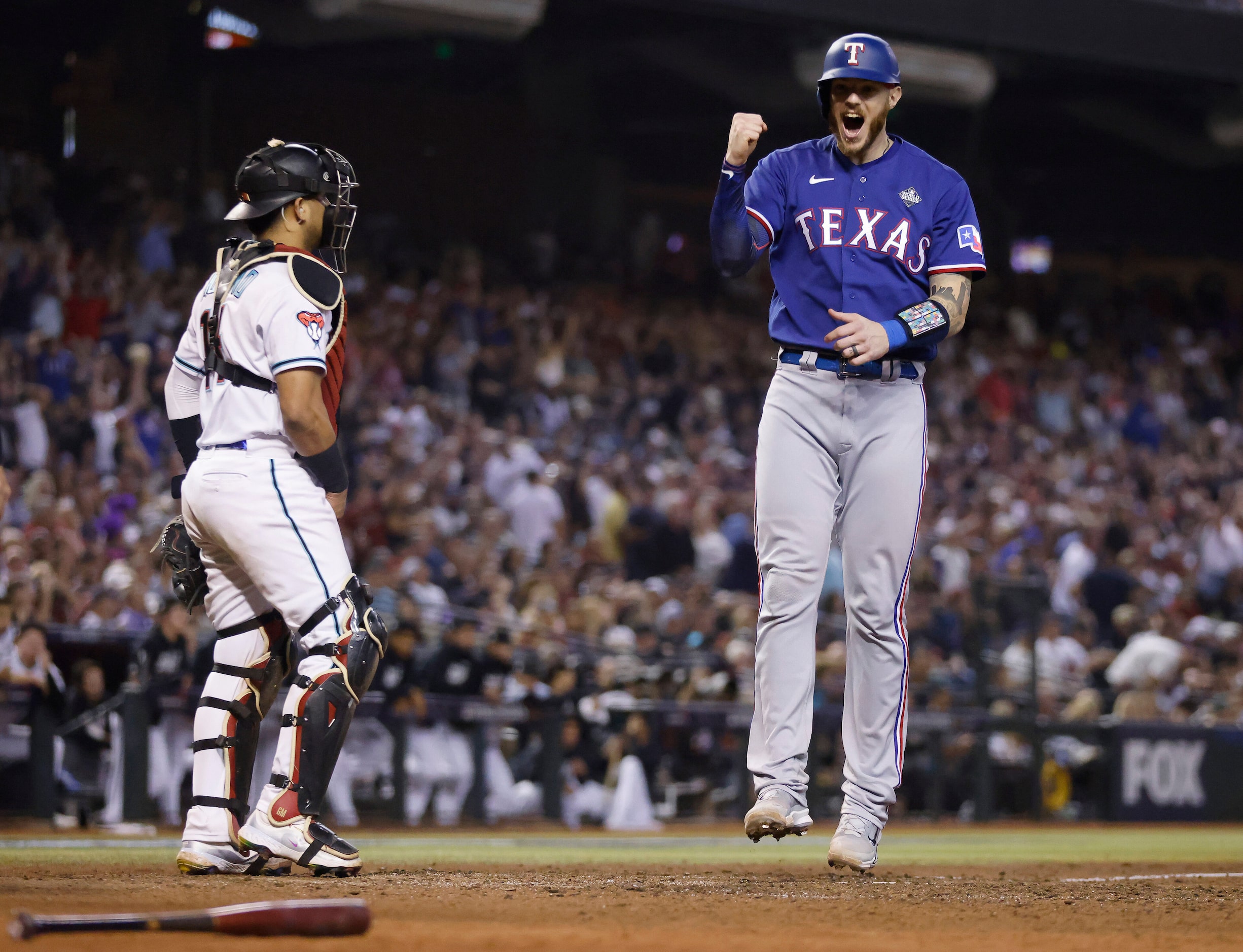 Texas Rangers Jonah Heim (28) crosses home plate on Marcus Semien’s home run to left center...