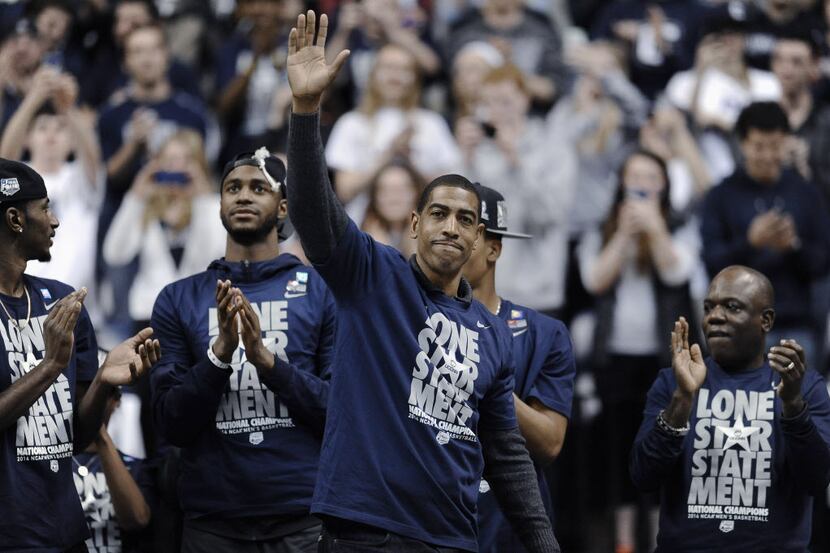 Connecticut coach Kevin Ollie waves to fans at a pep rally Tuesday, April 8, 2014, in...