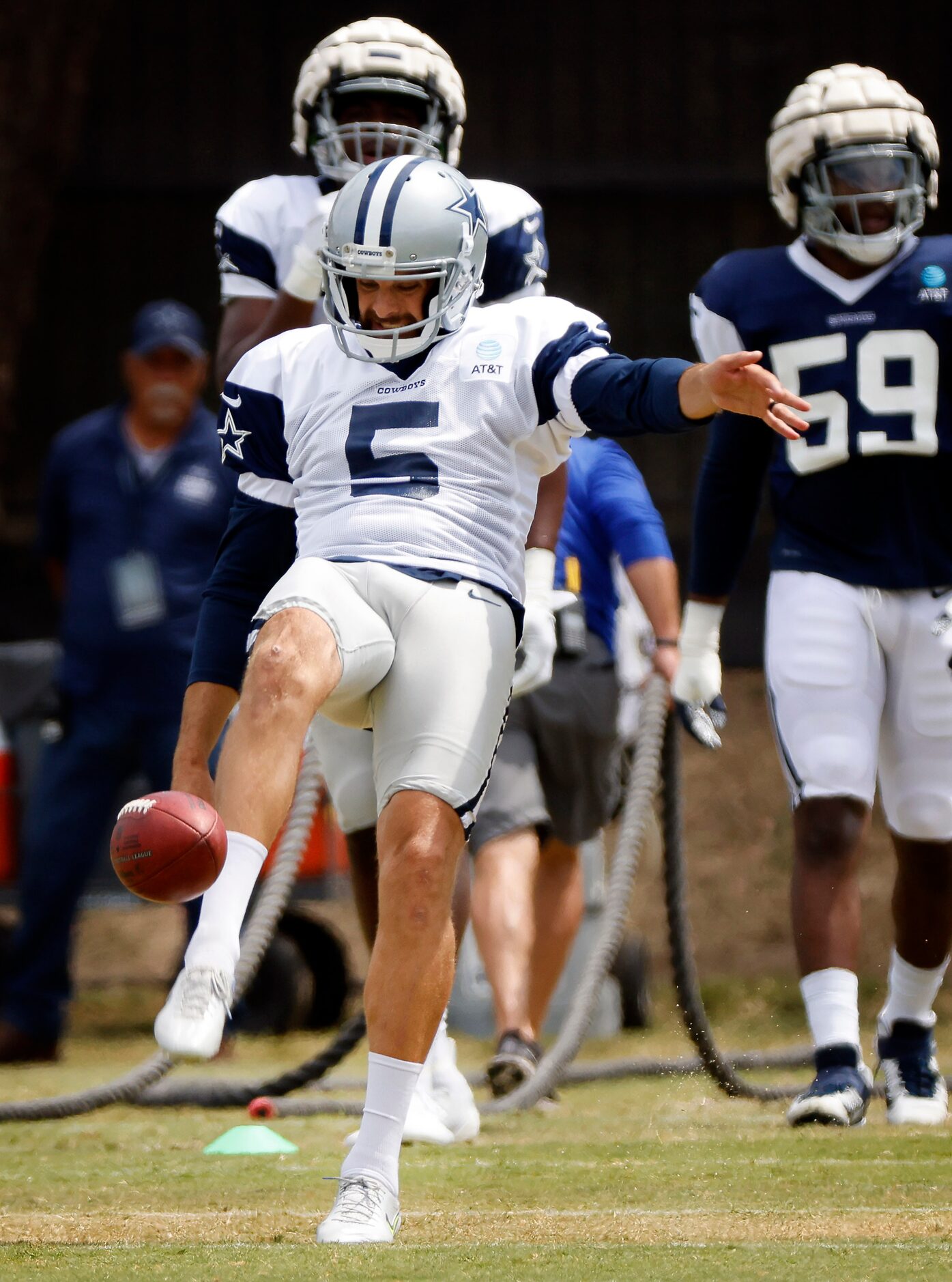 Dallas Cowboys punter Bryan Anger (5) kicks the ball during training camp practice in...