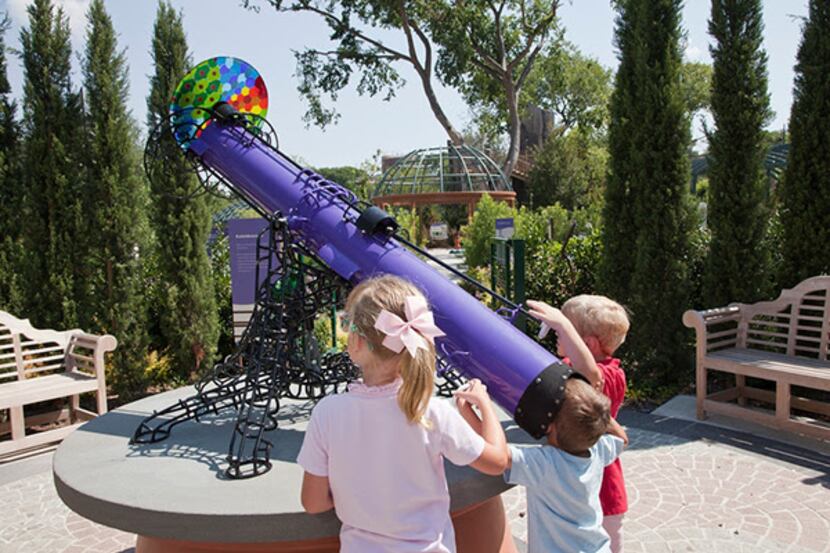 
Kids play with a telescope in the Dallas Arboretum and Botanic Garden.
