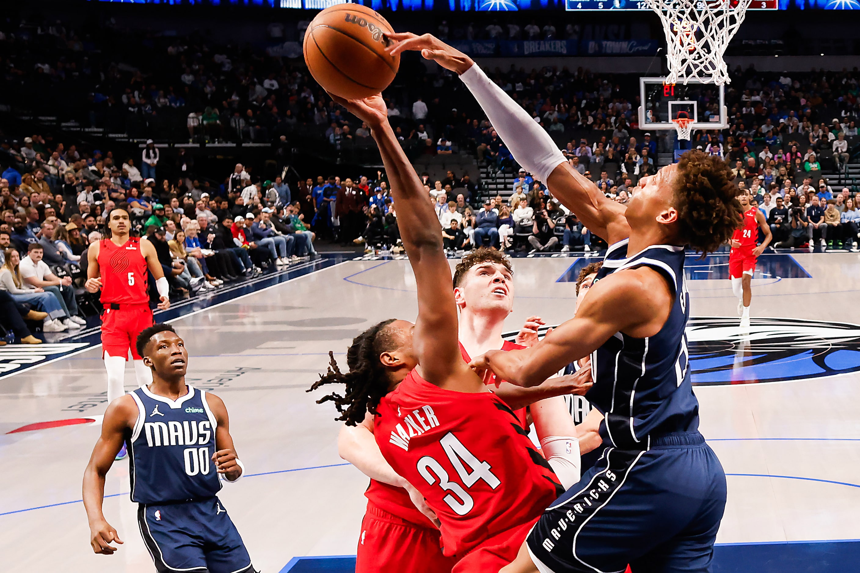 Dallas Mavericks forward Kessler Edwards (20) blocks a shot by Portland Trail Blazers...