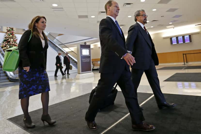 Special prosecutors Nicole DeBorde, left, Brian Wice, center, and Kent Schaffer leave the...