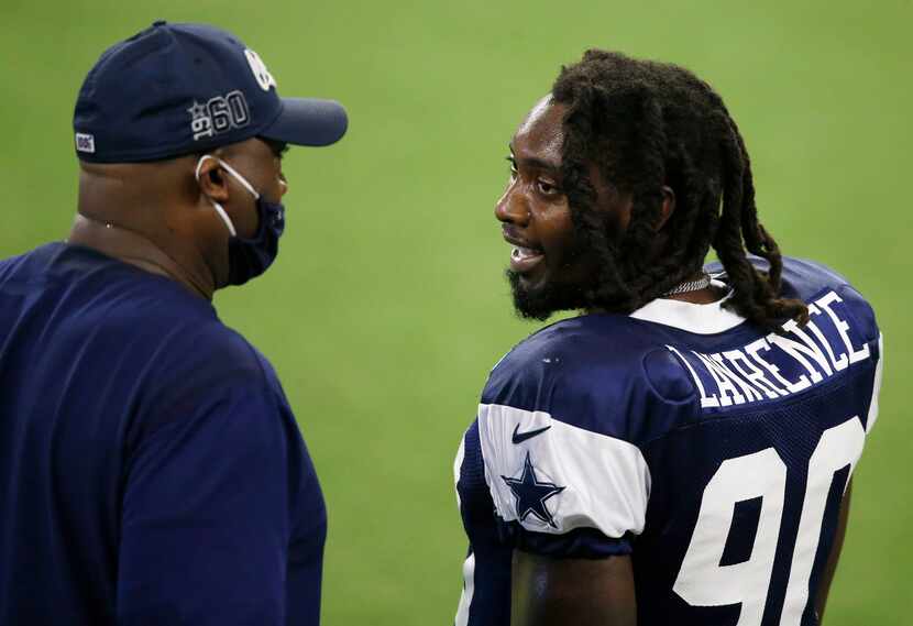 Dallas Cowboys defensive end DeMarcus Lawrence (90) talks with Dallas Cowboys assistant...
