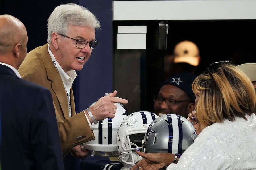 Texas Lt. Gov. Dan Patrick signs autographs before an NFL football game between the Dallas...