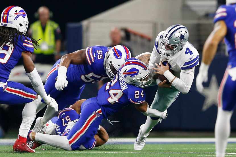 Dallas Cowboys quarterback Dak Prescott (4) is tackled after a run by Buffalo Bills...
