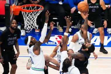 Dallas Mavericks guard Kyrie Irving (11) shoots over Minnesota Timberwolves forward Jaden...
