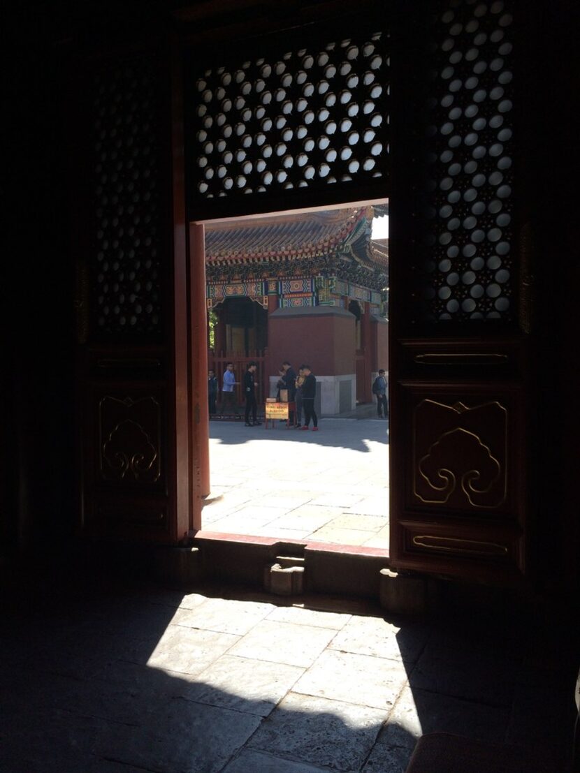 A threshold at the Yonghe Temple in Beijing provides a play of shadow and light.