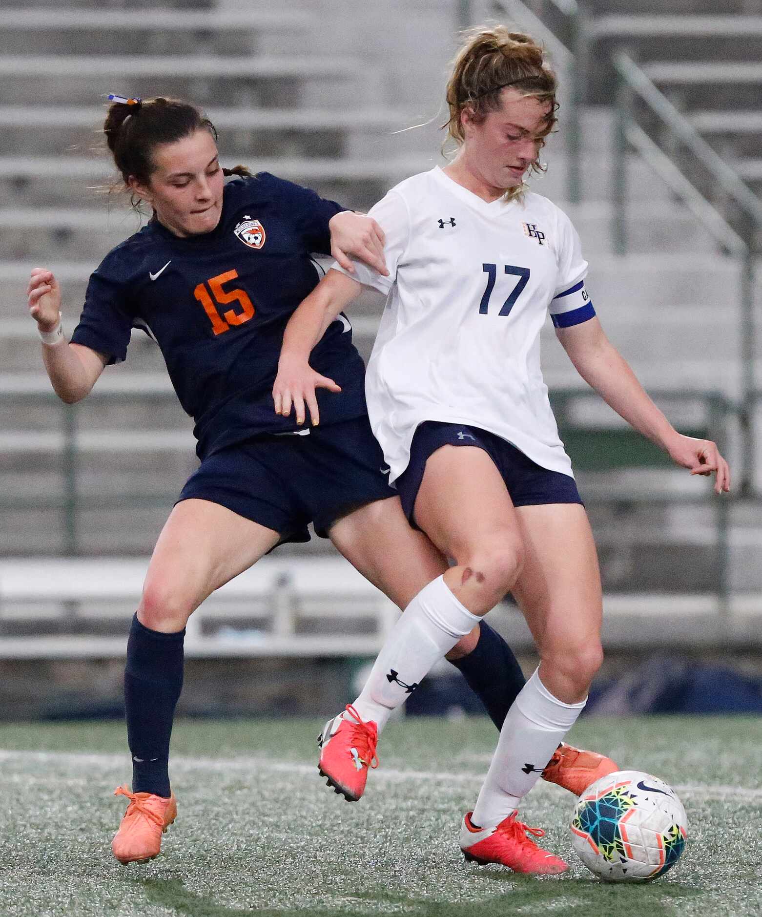 Wakeland midfielder Allie Perry (15) is sheilded from the ball by Highland Park defender...