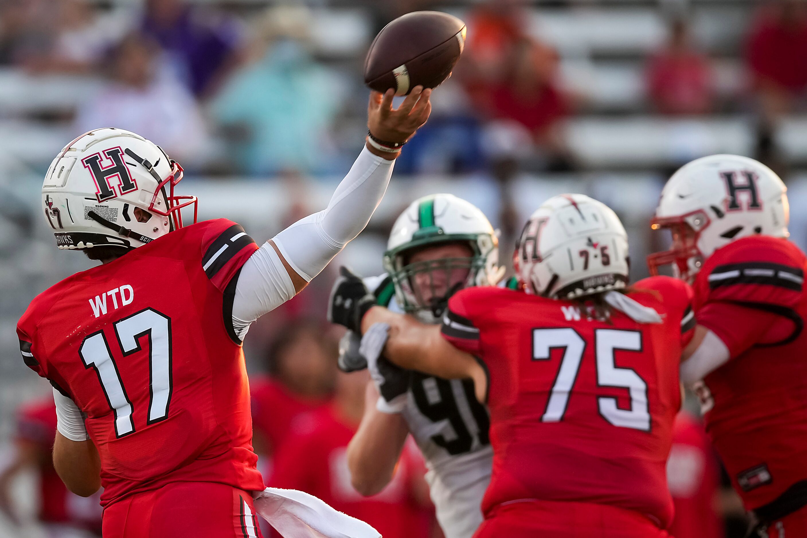 Rockwall-Heath quarterback Josh Hoover (17) throws a 58-yard touchdown pass to Jordan Nabors...