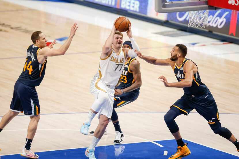 Dallas Mavericks guard Luka Doncic (77) attempts a shot as Utah Jazz forwards Bojan...