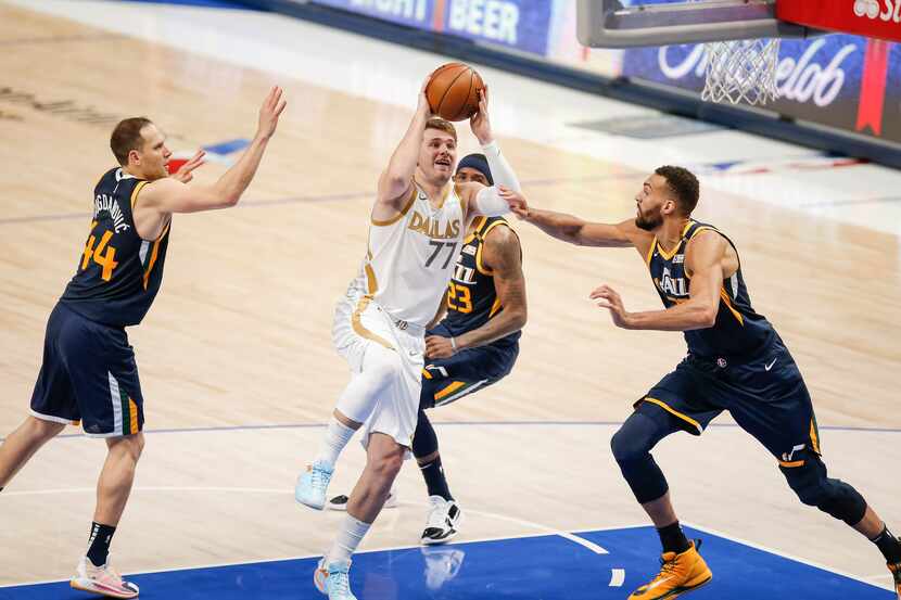 Dallas Mavericks guard Luka Doncic (77) attempts a shot as Utah Jazz forwards Bojan...