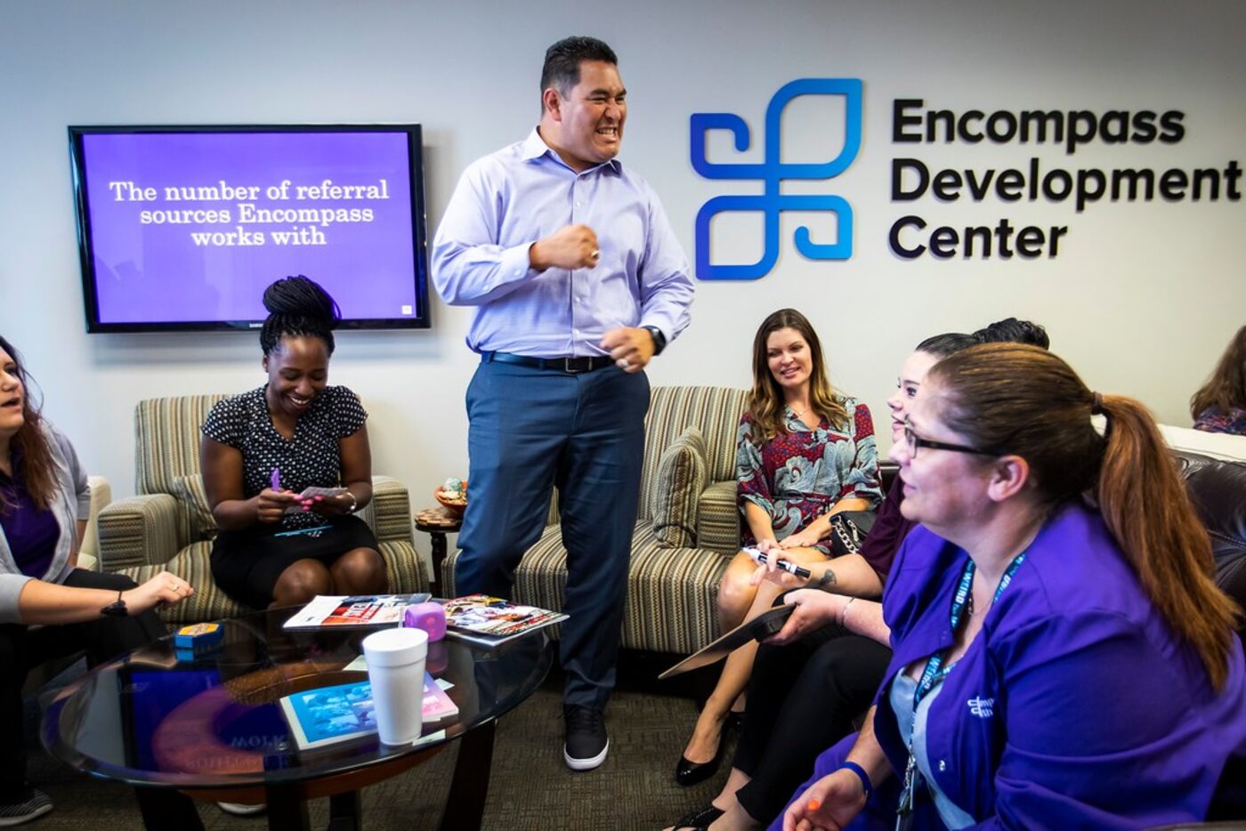 Encompass Home Health & Hospice employee Richard Viscarra (standing) celebrates his team's...