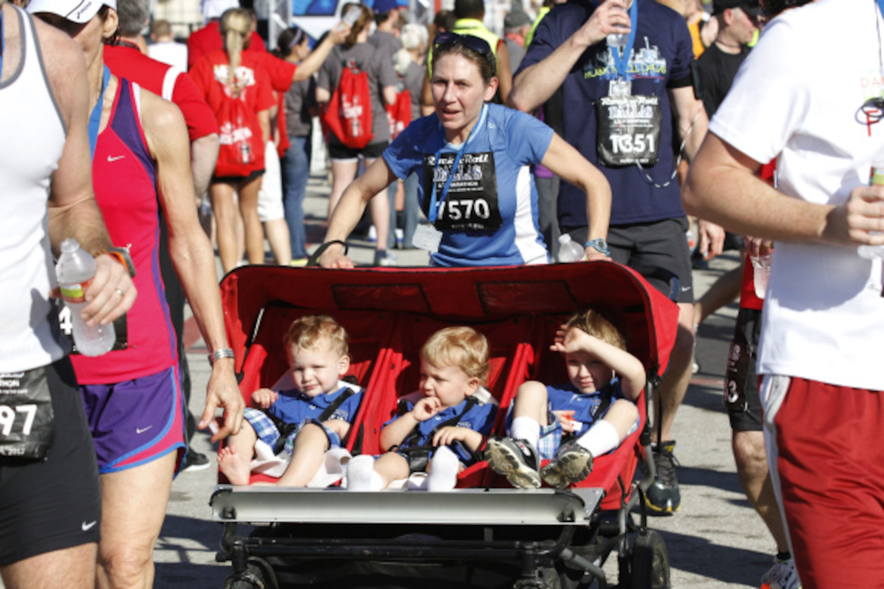 Tiffany Albrecht of Dallas finishes the Dallas Rock 'N' Roll half marathon with her...