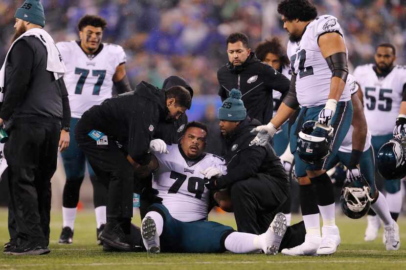 Philadelphia Eagles offensive guard Brandon Brooks (79) is helped up after being injured in...