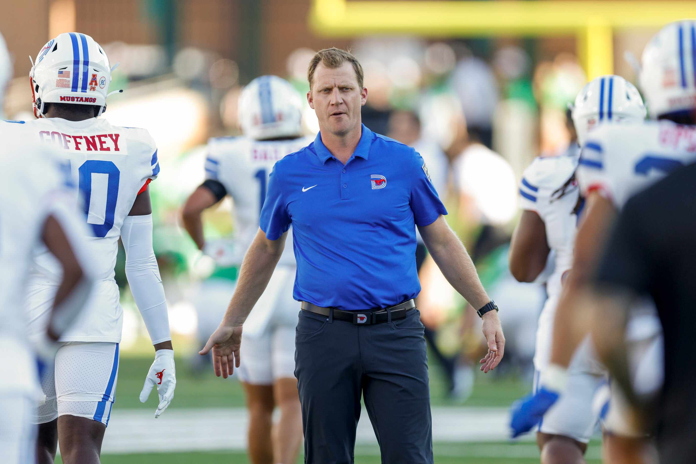 SMU head coach Rhett Lashlee high-fives players during warm-ups before a game against UNT at...