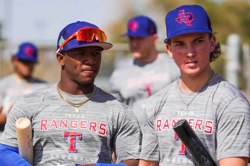 Infielders Luisangel Acuna (left) and Cameron Cauley wait their turn in the batting cage...