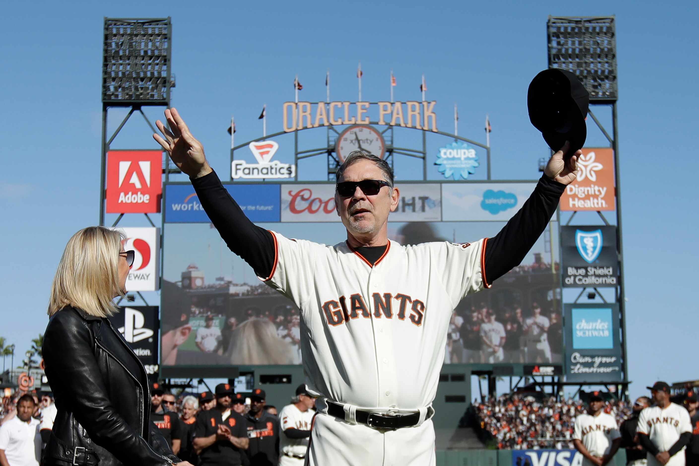 FILE - San Francisco Giants manager Bruce Bochy gestures toward fans next to his wife Kim...