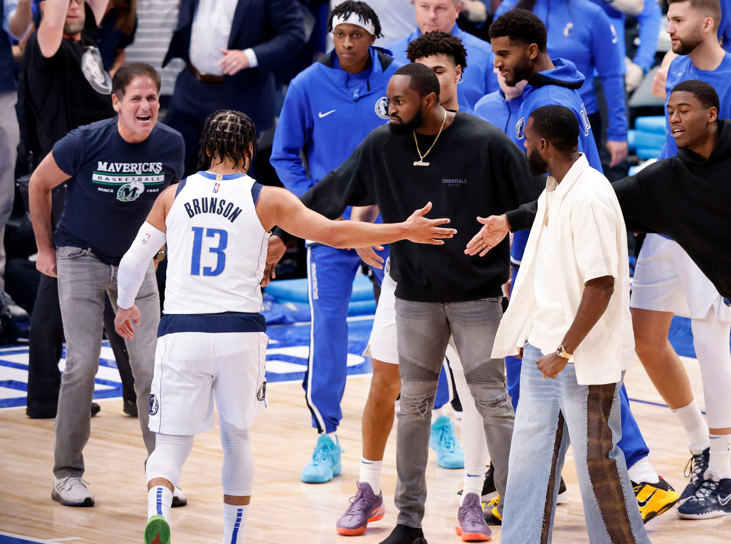 Dallas Mavericks guard Jalen Brunson (13) is congratulated by teammates after he got off to...