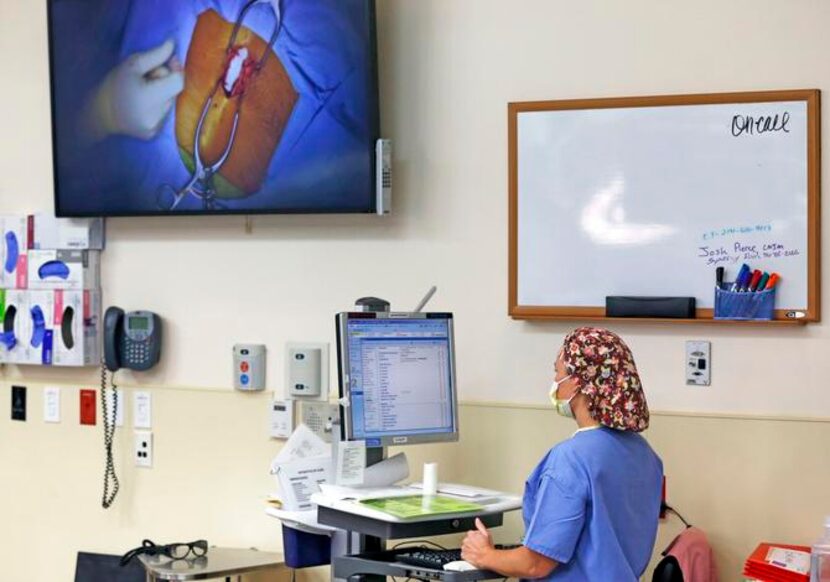 
Sunny Austin, a registered nurse, uses the computer at Texas Health Arlington Memorial...