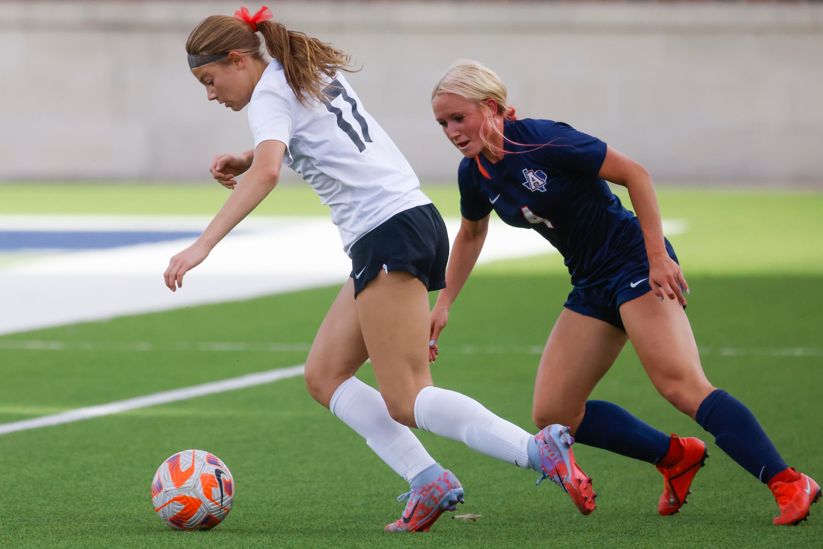 Marcus’ Madi Patterson (left) runs past Allen’s Alexa Barker during the first half of a...