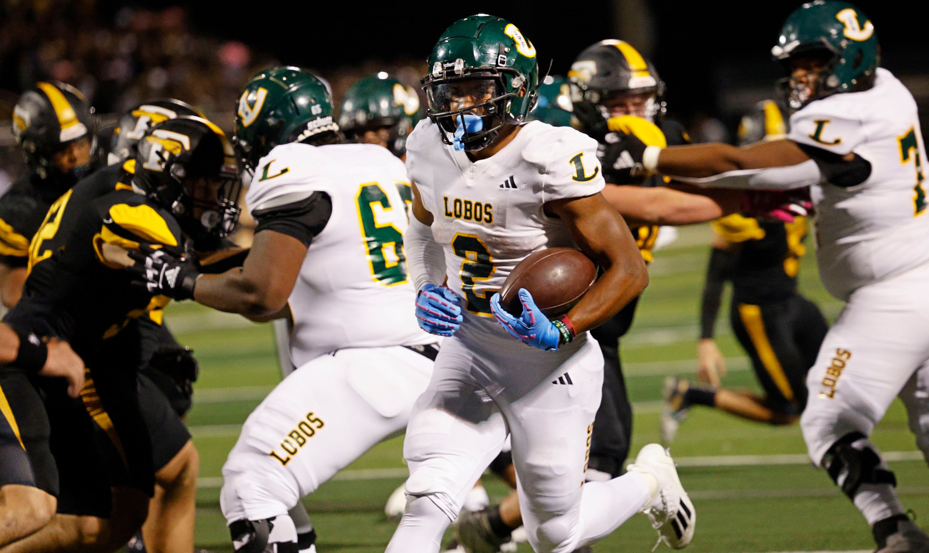 Longview's Taylor Tatum (2) scores a touchdown over Forney during the first half of a high...