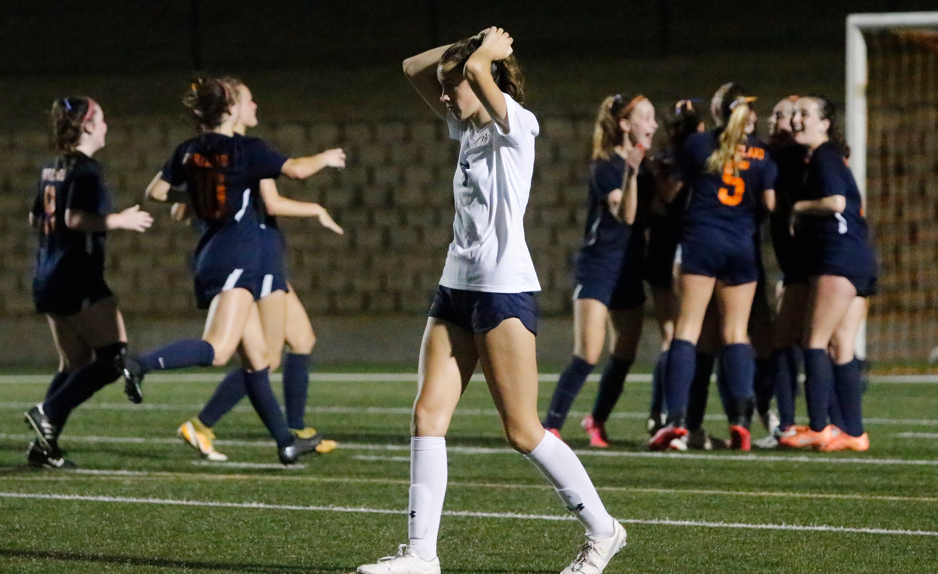 Highland Park midfielder Hattie Patterson (8) reacts as Wakeland celebrates a goal in the...